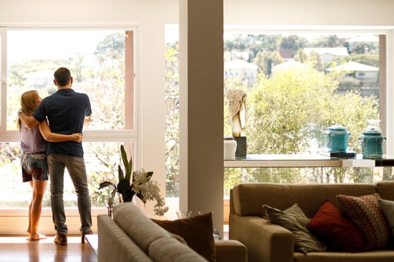 When Do I Replace My Air Conditioner in Boulder? Photo of a couple in their living room admiring the view.